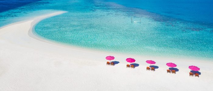 Aerial view of tropical beach nature as summer landscape with lounge chairs umbrella and calm sea for beach banner. Luxurious travel landscape, beautiful destination for vacation holiday. Summer beach